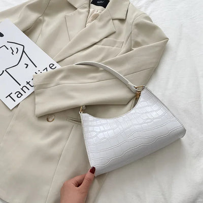 Georgina | A shiny shoulder bag with an alligator pattern