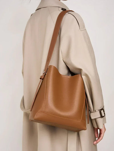 Moxie™ – A stylish sand-colored shoulder bag with a strap handle