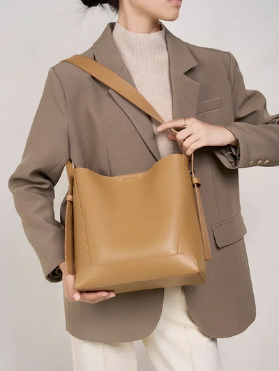 Moxie™ – A stylish sand-colored shoulder bag with a strap handle