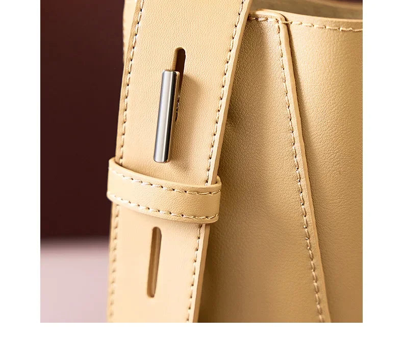 Moxie™ – A stylish sand-colored shoulder bag with a strap handle