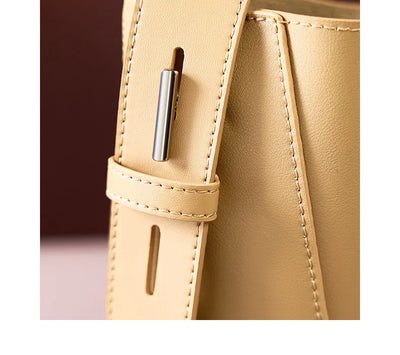 Moxie™ – A stylish sand-colored shoulder bag with a strap handle