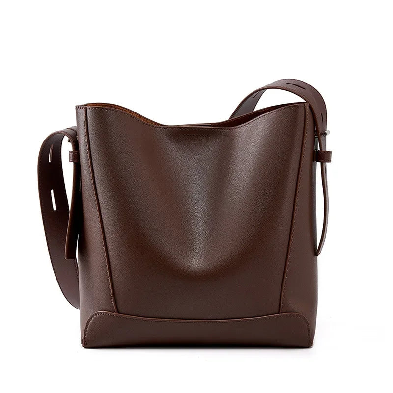 Moxie™ – A stylish sand-colored shoulder bag with a strap handle