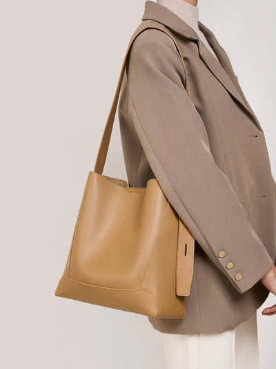 Moxie™ – A stylish sand-colored shoulder bag with a strap handle