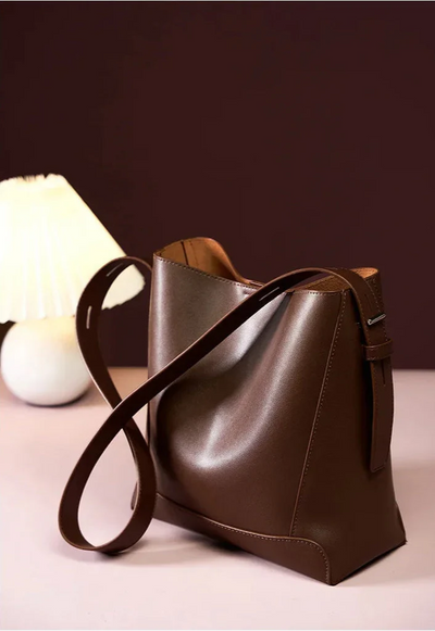 Moxie™ – A stylish sand-colored shoulder bag with a strap handle