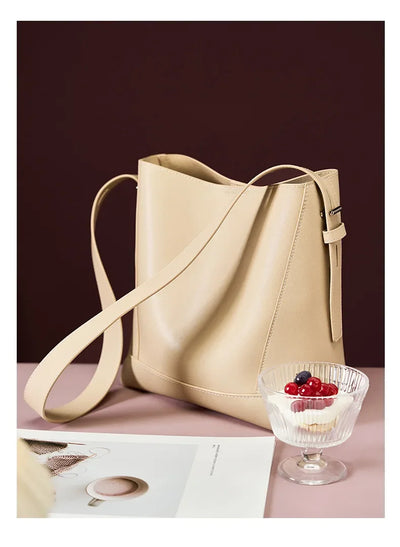 Moxie™ – A stylish sand-colored shoulder bag with a strap handle